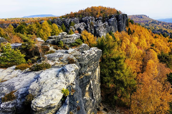 Experience the stunning fall colors of the Bohemian-Saxon Switzerland National Park where towering rock formations meet breathtaking vistas perfect for capturing unforgettable travel memories.